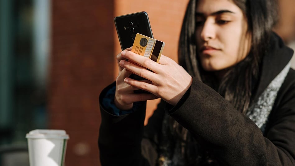 woman-holding-phone-and credit-card